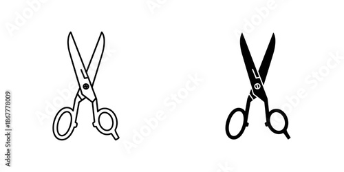 Two pairs of scissors with magnifying glasses on handles