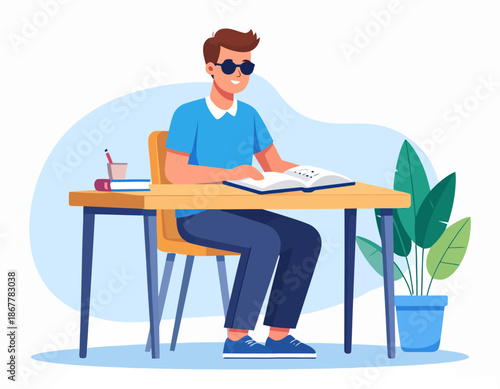 A visually impaired young man wearing sunglasses studying at a desk with a book open, surrounded by a plant and art supplies