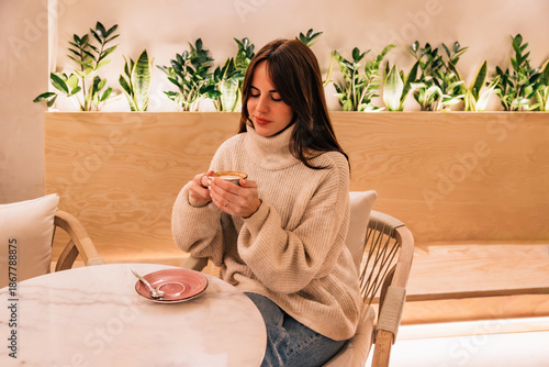 Woman enjoying coffee creating a cozy relaxed cafe atmosphere
