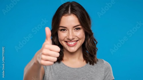 Wallpaper Mural A smiling woman giving a thumbs up against a blue background. Torontodigital.ca