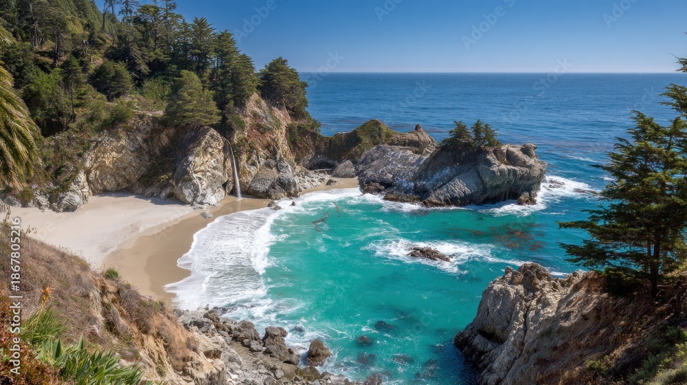 Fototapeta premium Scenic coastal inlet features a secluded beach fed by a small waterfall under a bright blue sky