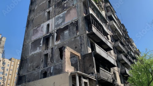 A devastated residential area with burned buildings and scattered debris.