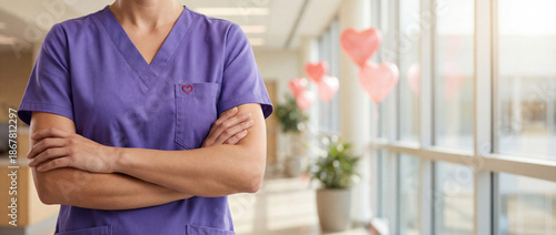 Confident Nurse in Purple Scrubs with Heart Symbol in Bright Hospital Hall Healthcare Trust Editorial Photography