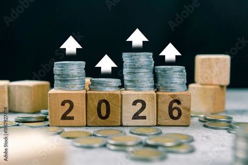 Fotografia Stack of coins, 2026 wooden text block, and up arrow indicating increase