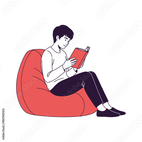 A young man comfortably reading a book while sitting on a large beanbag chair, enjoying a moment of leisure and learning