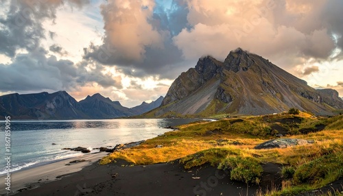 Dramatic landscape of mountain, lake and beach under cloudy sky