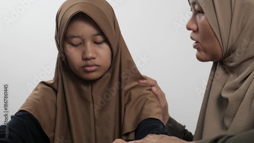 Muslim mother trying to persuade and calm her angry, disappointed and stubborn teenage daughter