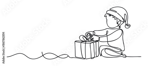 Young child wearing a Santa hat preparing to unwrap a holiday gift with excitement, perfect for Christmas season promotions, greeting cards, and festive event invitations.