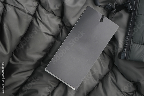 Quadro em tela Black tag on a puffy jacket background in a close view