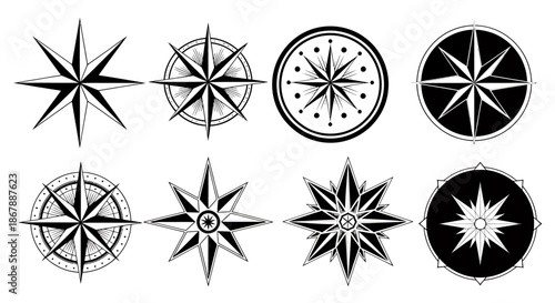 Set of eight different black and white compass rose icons with various decorative designs.