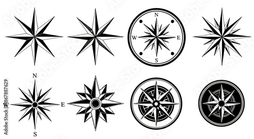 Set of eight black and white vintage compass rose icons with different decorative designs.