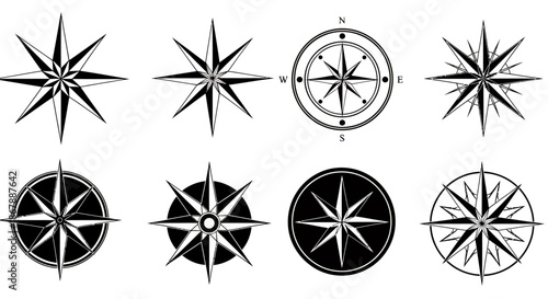 Set of eight different black and white compass rose icons for navigation and direction.