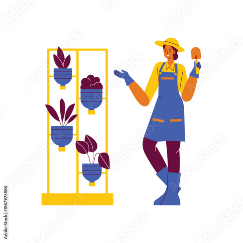 Female Gardener in Overalls Holding Mushroom by Vertical Planter.