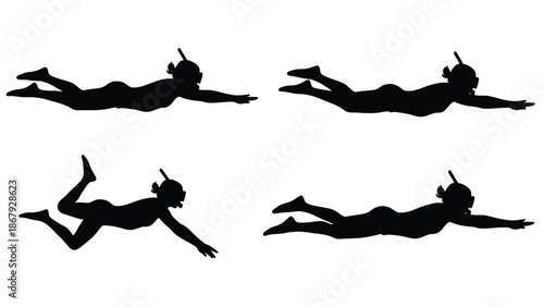 Silhouettes of people snorkeling in ocean