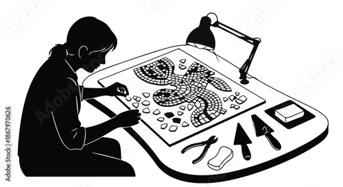 Focused artisan meticulously crafting a mosaic artwork with tools and lamp