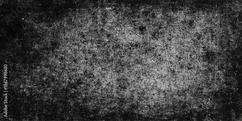 Aged dark grunge texture with a rough black and white vintage pattern on an old dirty concrete wall surface for a textured grey stone backdrop wallpaper
