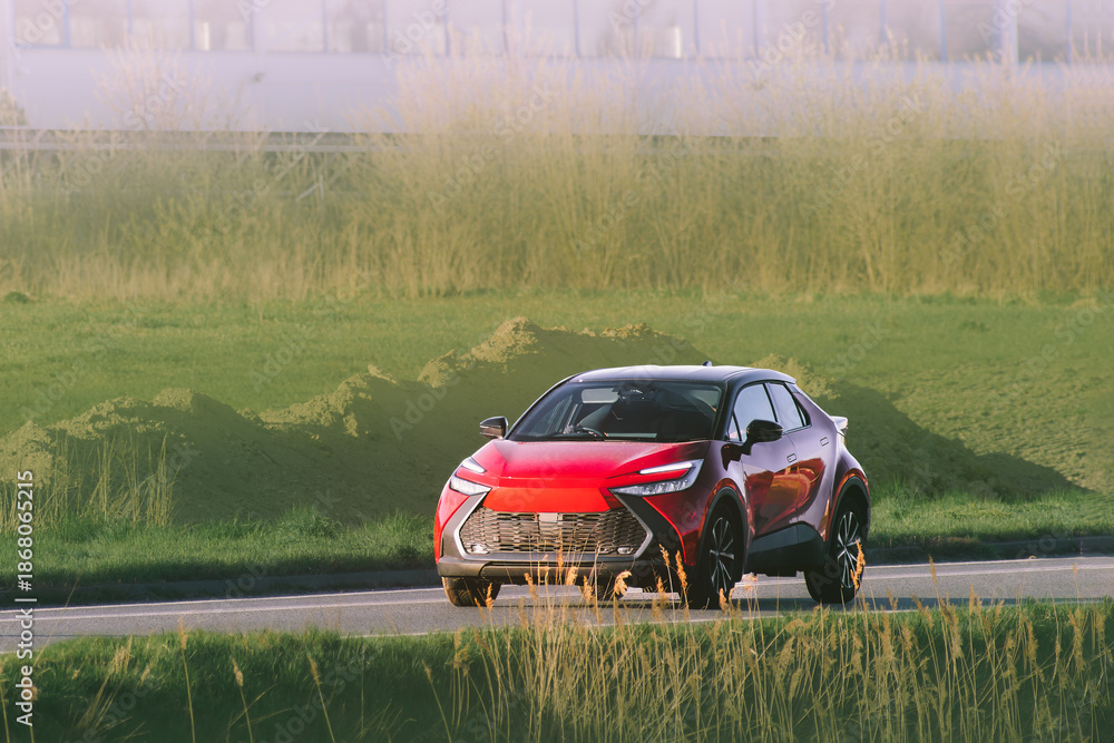 Fototapeta premium Crossover car driving in a tranquil natural area