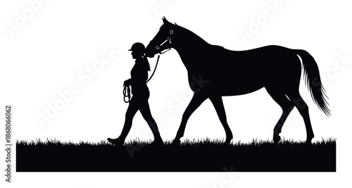 Silhouette of an equestrian woman in a helmet walking a majestic horse on a grassy field, perfect for depicting horseback riding, animal companionship, or equestrian sport themes in various
