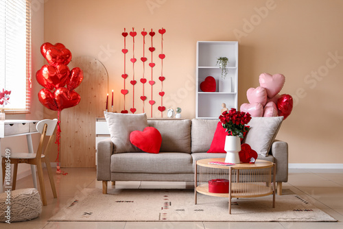 Interior of living room decorated for Valentine's Day with sofa, table and balloons