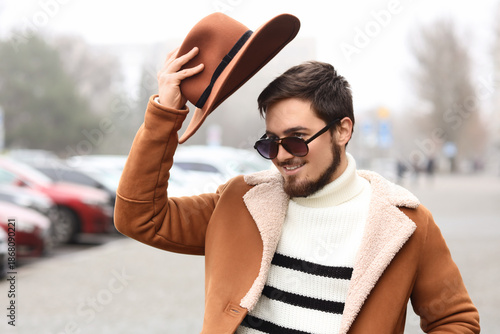 Stylish young man with sung...