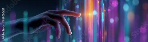 A hand reaches toward vibrant, colorful light beams, symbolizing interaction with technology and digital innovation.