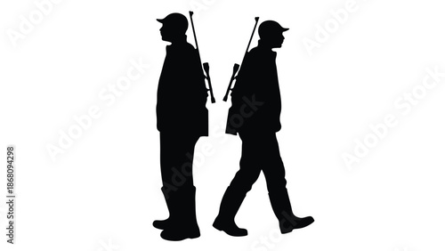 Two men walking in silhouette with rifles on their shoulders