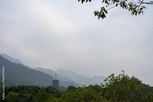 Amidst the rolling mountains stands a pagoda.
