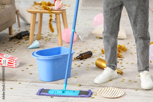 Legs of man mopping floor a...