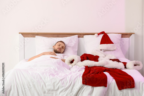 Young man with Santa costum...