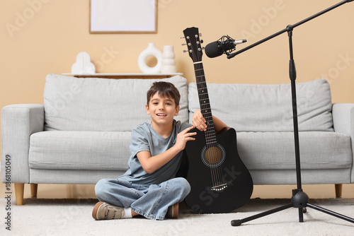 Cute boy with guitar and mi...