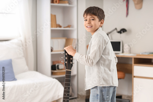 Cute boy with guitar in bed...
