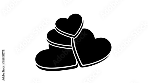 Stack of black heart-shaped chocolates arranged together