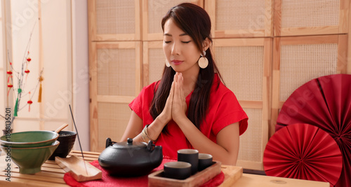 Young Asian woman with tea ...