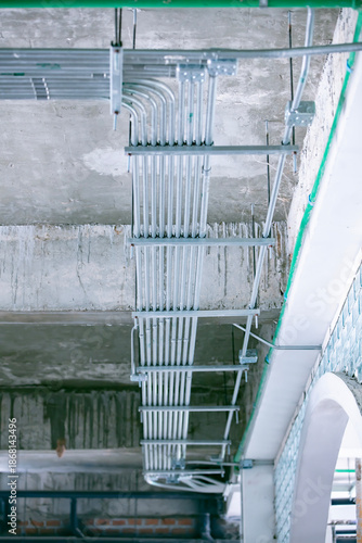 Industrial infrastructure: An architectural perspective that unveils a detailed arrangement of pipes, showcasing the essential arteries of a building's mechanical systems.