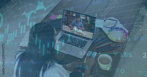 Guiding mom in light top writing notes at home desk, laptop showing child, data-overlay, copy space