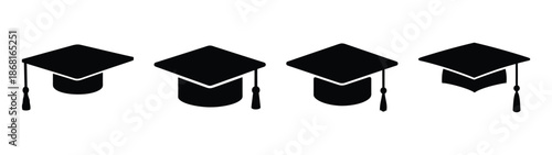 Four black graduation caps with tassels celebrate academic achievement and education milestone