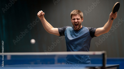 A man is playing ping pong and is about to hit the ball