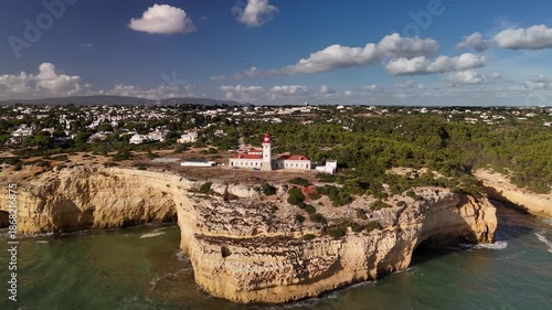 Drone Orbit of Alfanzina Lighthouse on Coastal Cliffs near Carvoeiro, Algarve, Portugal