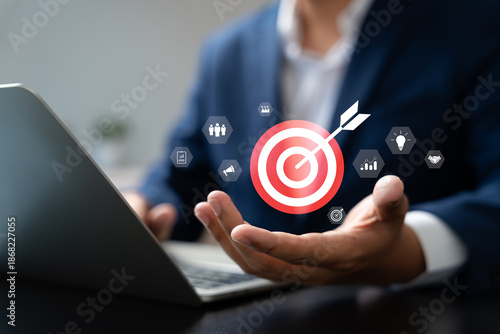 Concept of business strategy and future sustainable business finance action plan. Hand holding target board for creative and set up business objective target and success and business goals concept.