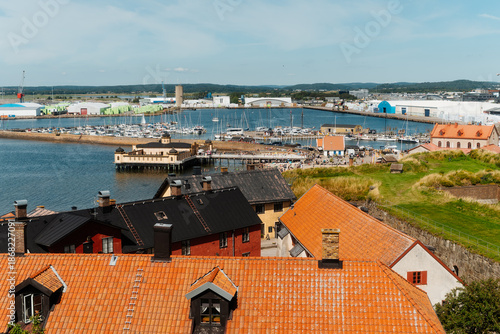 High angle view of Varberg cityscape with red rooftops, the historic Cold Bath House and harbor, Sweden