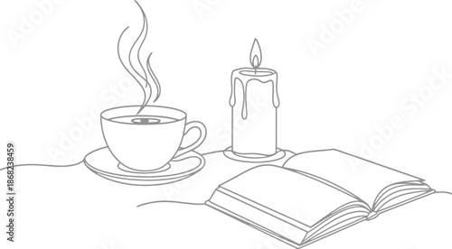A cup of coffee and a book with candle