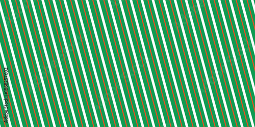 Christmas seamless pattern. Red and green diagonal stripes background. Candy cane repeating decoration wallpaper.
