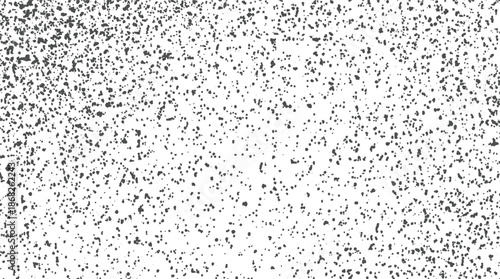 Monochrome speckled texture background featuring a gradient of dark particles from dense to sparse on a white canvas for versatile applications