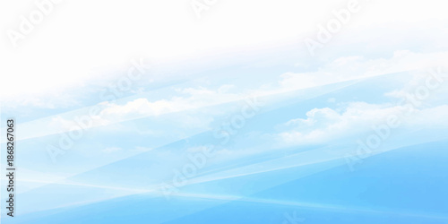 A clear blue sky background with fluffy white clouds and bright sunlight creates a beautiful summer day atmosphere in this high outdoor nature cloudscape