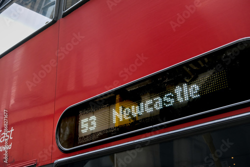 Photos Red double-decker bus with digital display showing route 53 to Newcastle, captured in an urban UK setting