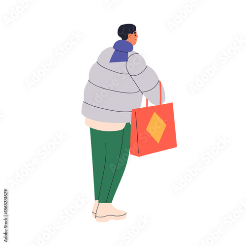 Asian man standing with shopping bag outdoors, view from back, behind. Chines...