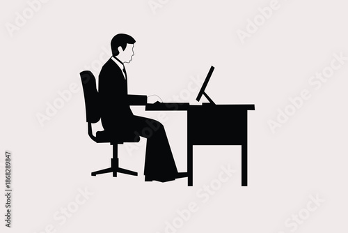 silhouette of a man working on a laptop