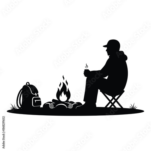 Man sitting by campfire with backpack silhouette relaxing outdoor