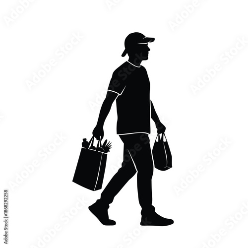 Man carrying grocery shopping bags silhouette walking side view