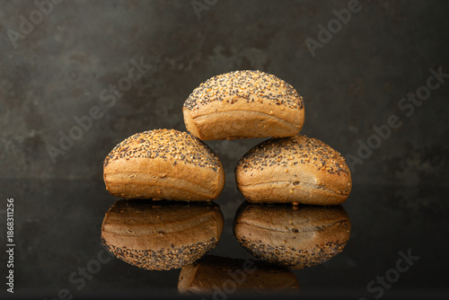 Fresh Poppy Seed Rolls on Dark Surface